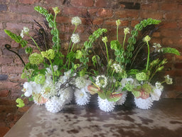 Whie wases with bells of Irland hydrangea, anthuriums leucadendron viburnum