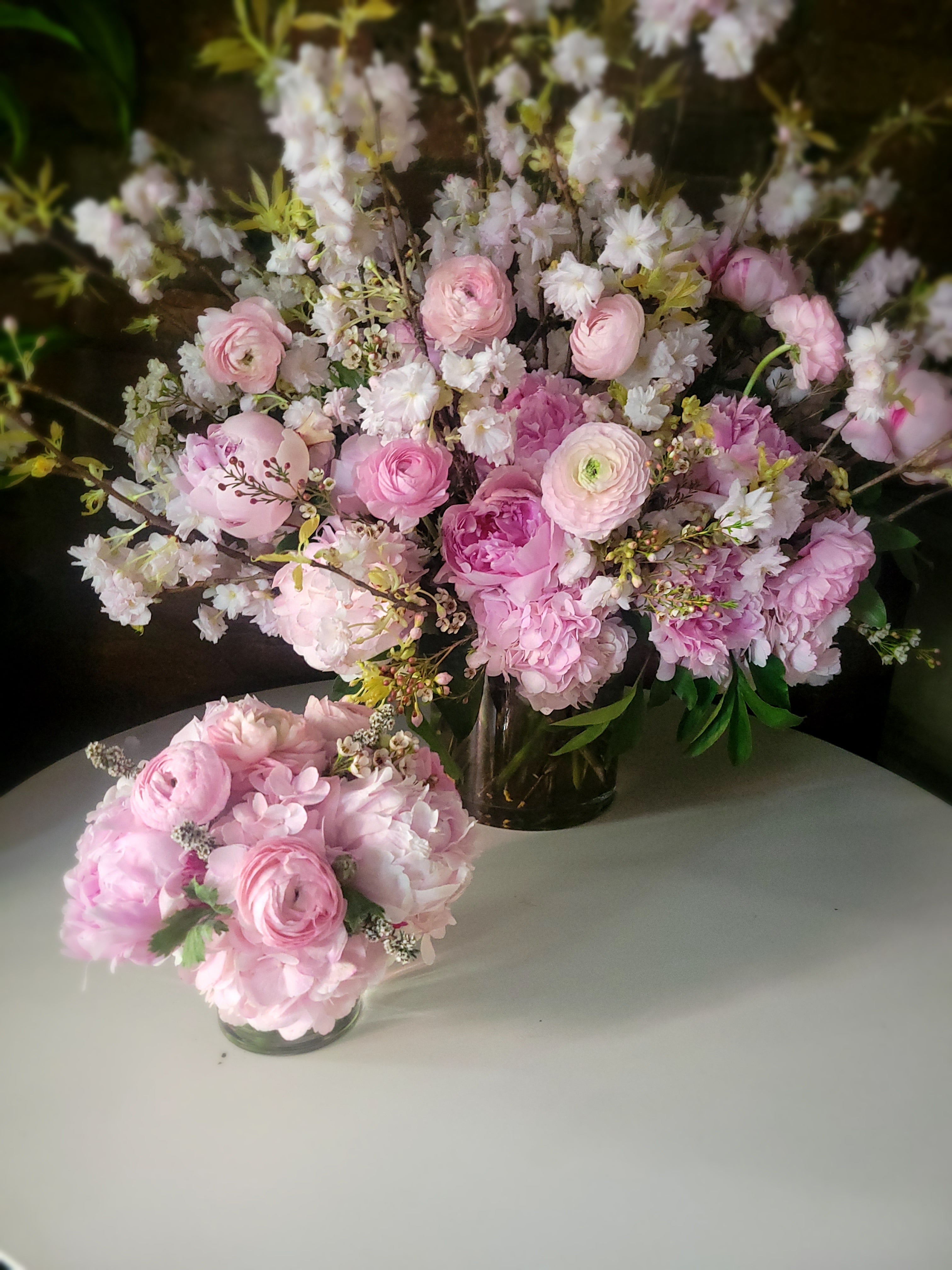 Arrangement with cherry blossoms peonies roses and pink hydrangea