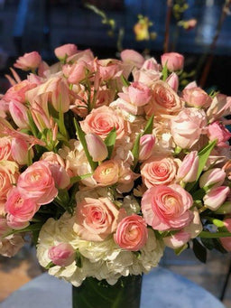 Arrangement with white hydrangea tulips roses and ranunculus