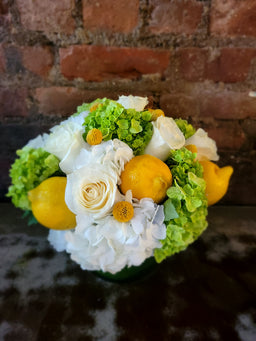 Arrangements white and green hydrangea whit roses lemons and Billy balls.