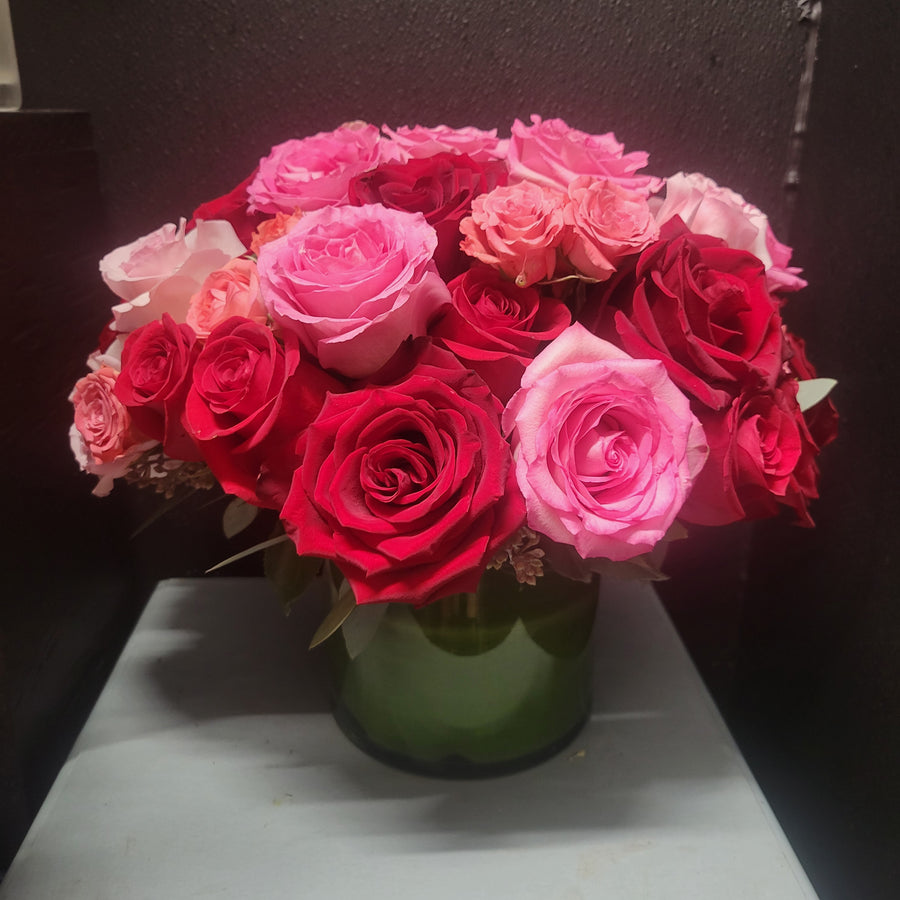 Arrangement with pink roses, spray roses and red roses 