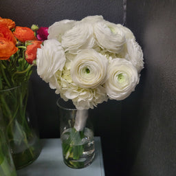 Wedding bouquet with white hydrangea and white ranunculus