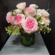 Arrangement with pink roses hellebore and ranunculus.